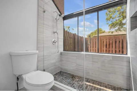 a bathroom with a toilet and shower