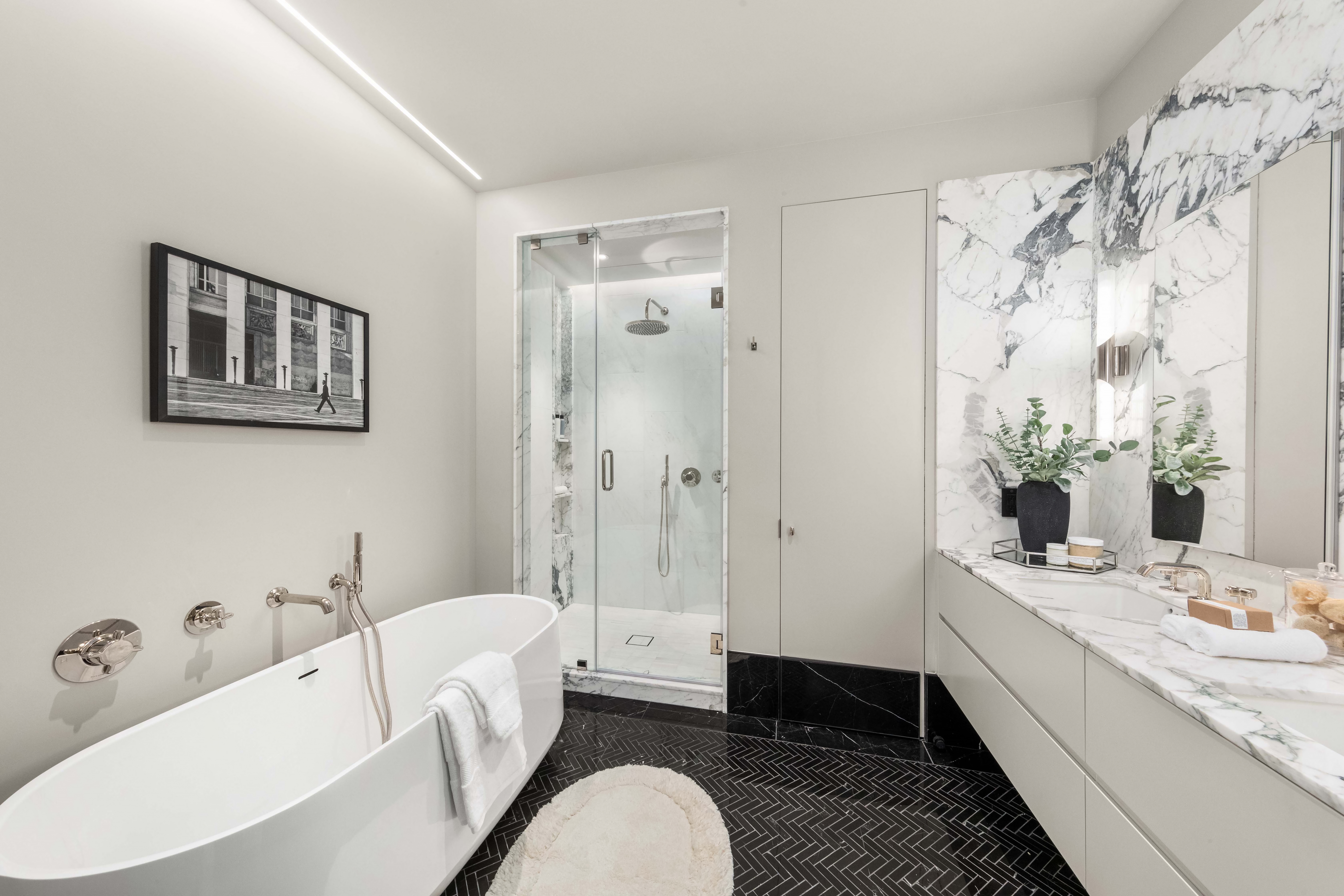 344 West 84th Street, Unit PH Manhattan, NY 10024 - Photo 7 of 11 a bathroom with a double vanity sink a mirror a bathtub and shower