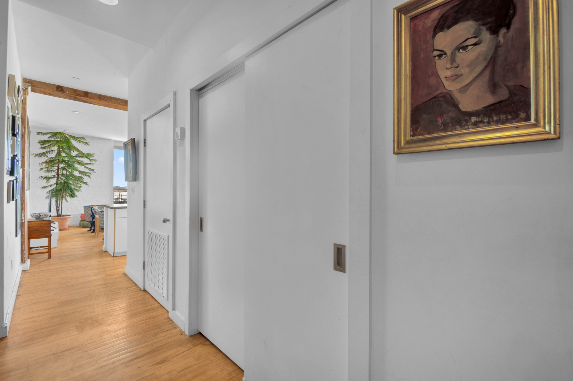 25 Carroll Street, Unit 4C Brooklyn, NY 11231 - Photo 18 of 27 a view of a hallway with paintings on the wall