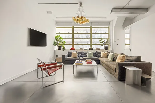 a living room with furniture a flat screen tv and a large window