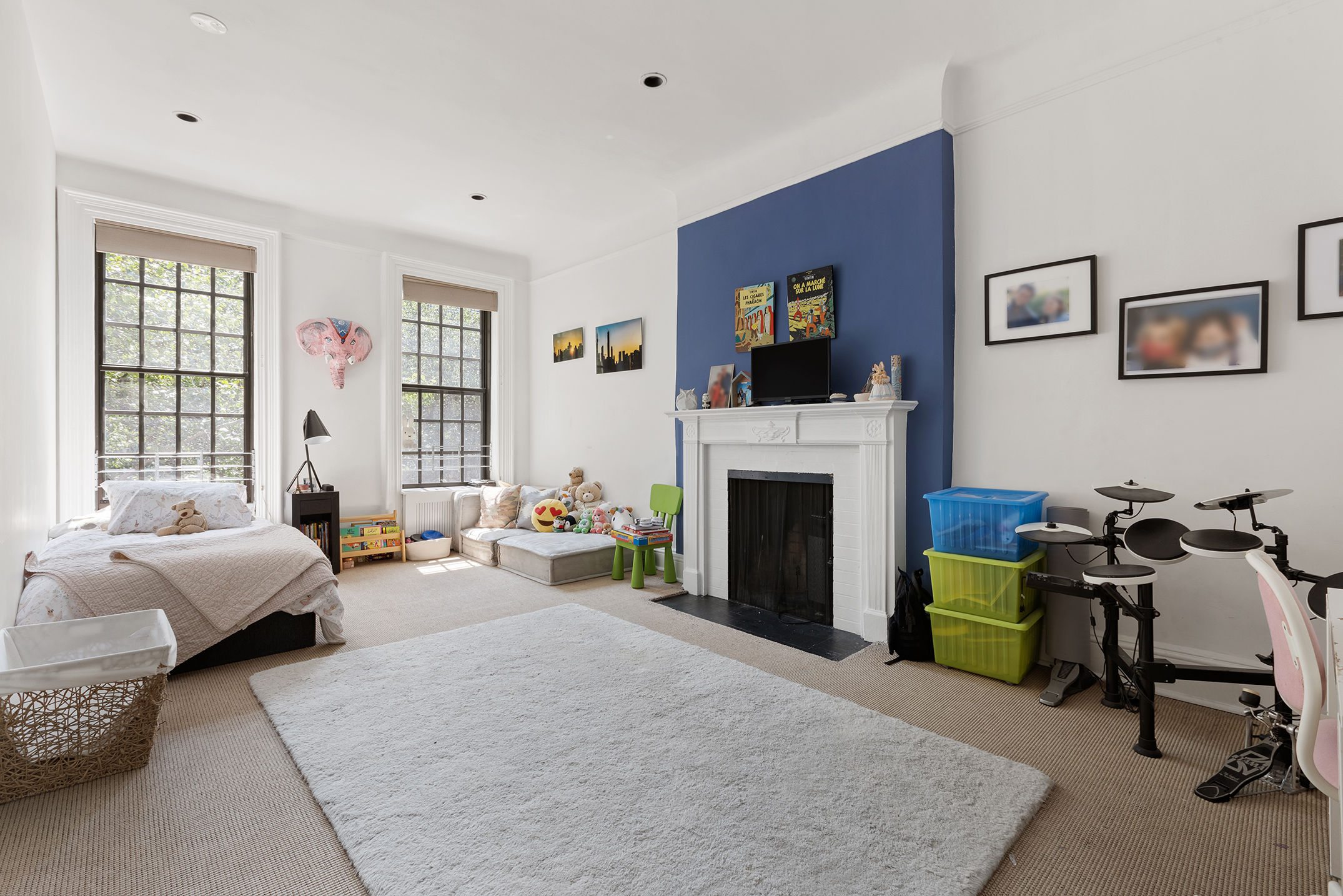 159 East 63rd Street, Unit 2/3 Manhattan, NY 10065 - Photo 9 of 13 a living room with furniture and a fireplace