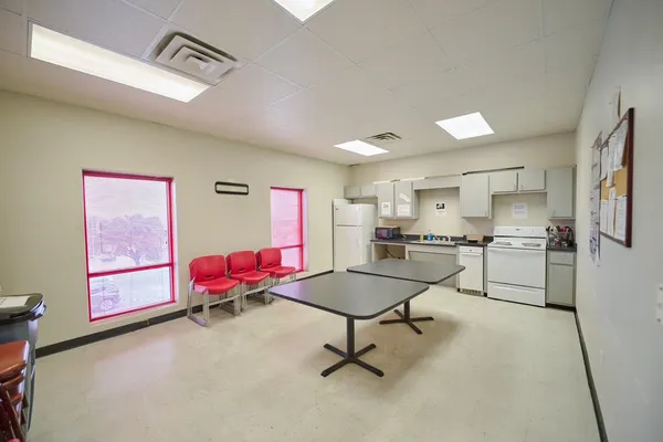 a kitchen with a checkered floor and a dining table with chairs