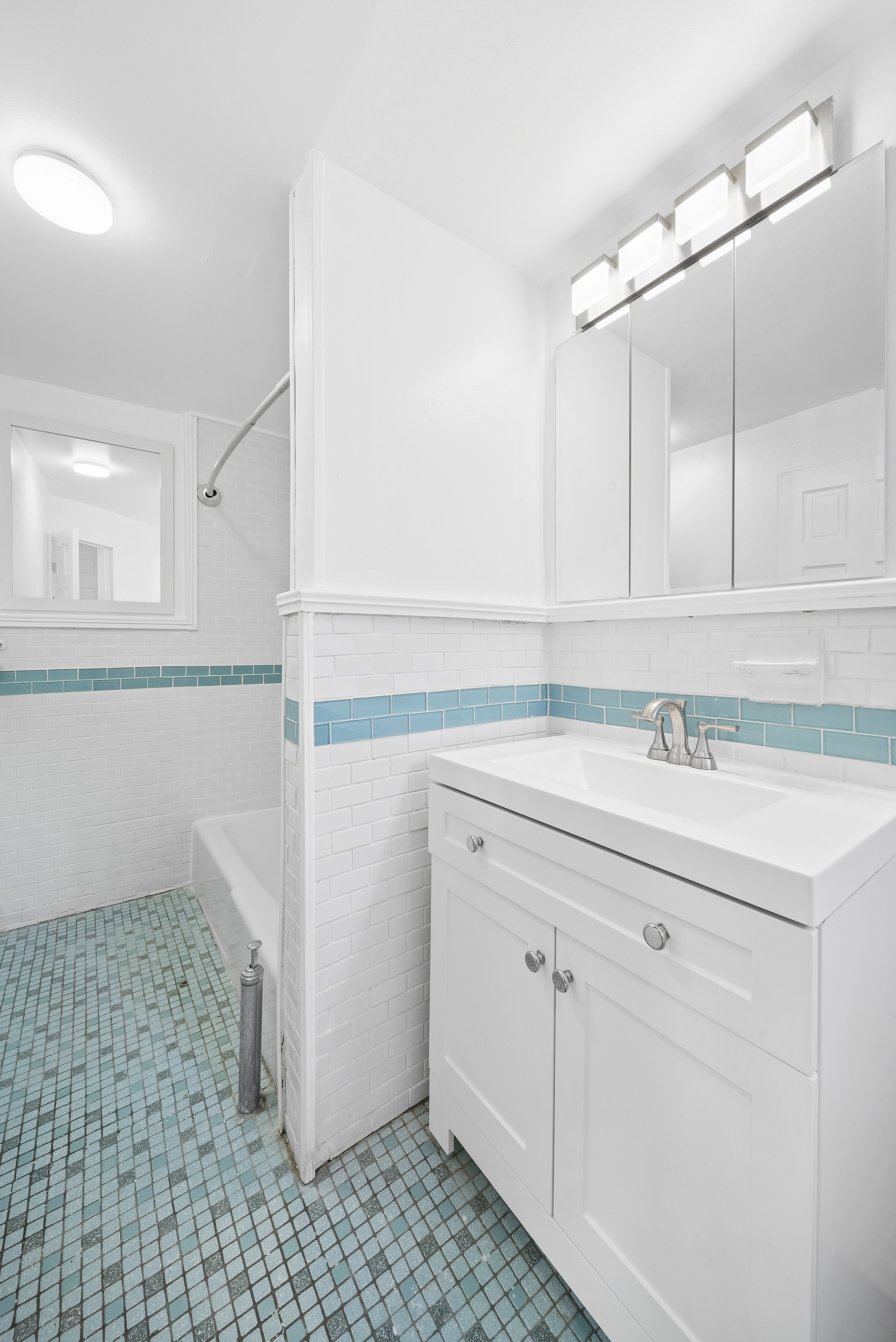 490 A Monroe Street, Unit apt.1 Brooklyn, NY 11221 - Photo 9 of 12 a bathroom with a sink a toilet and mirror