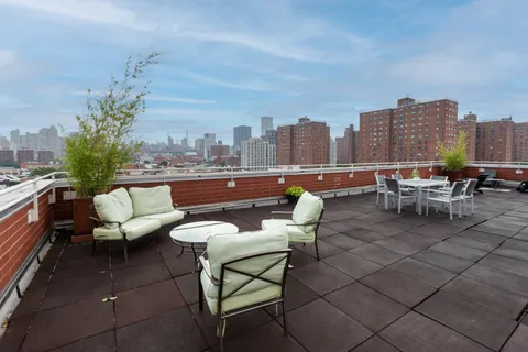 a terrace with outdoor seating city view and barbeque oven