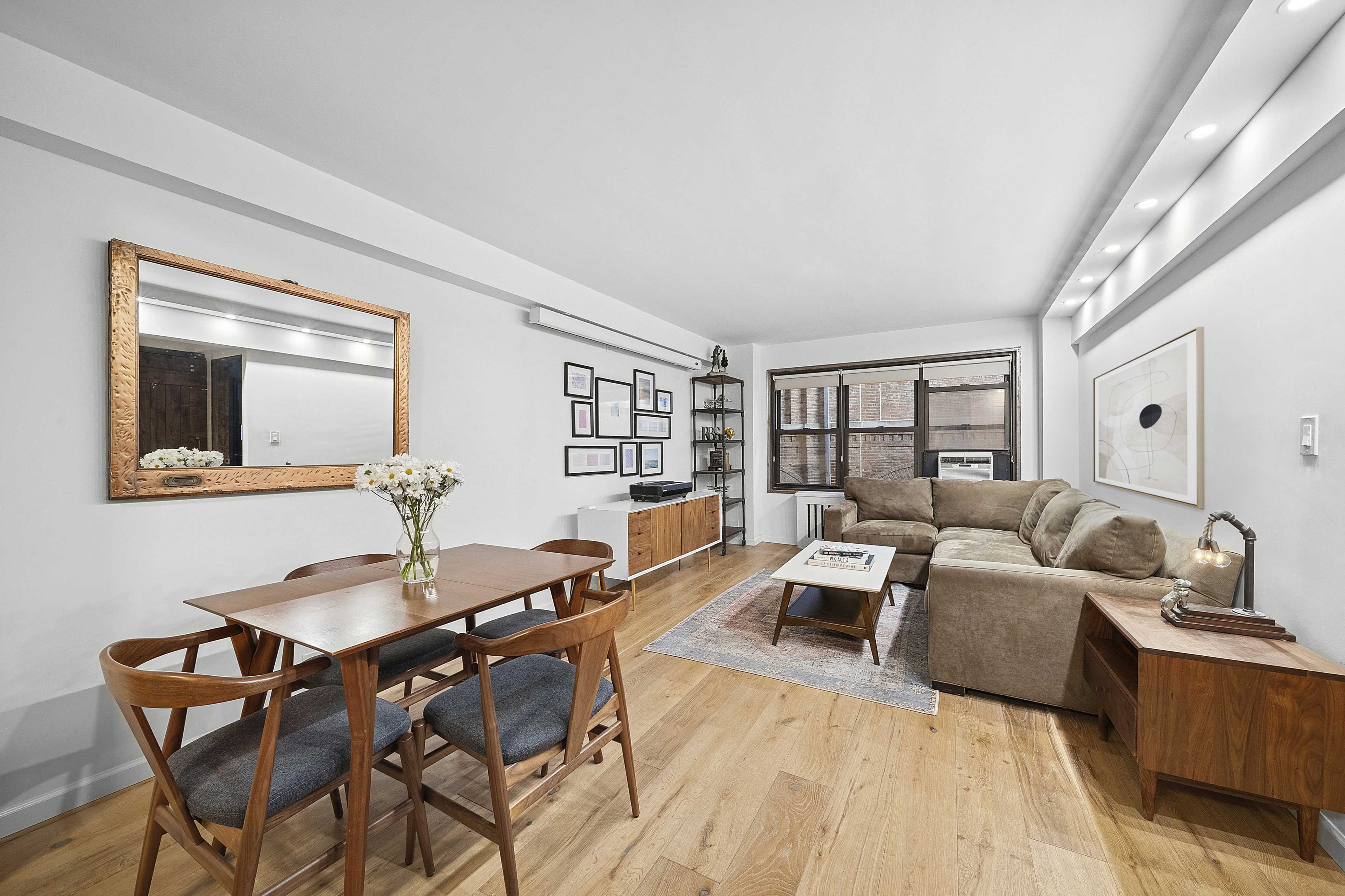 54 West 16th Street, Unit 2G Manhattan, NY 10011 - Photo 2 of 7 a living room with furniture and wooden floor