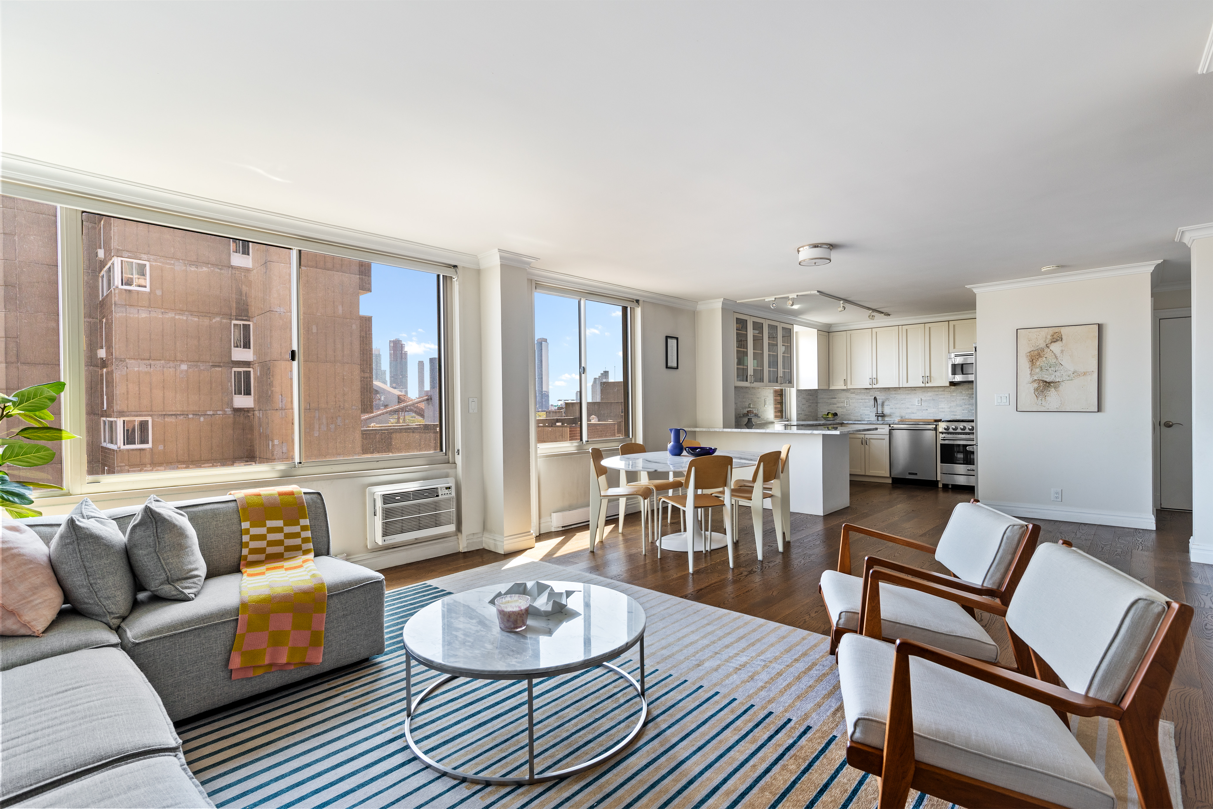 575 Main Street, Unit 1312 Manhattan, NY 10044 - Photo 4 of 25 a living room with furniture and a large window