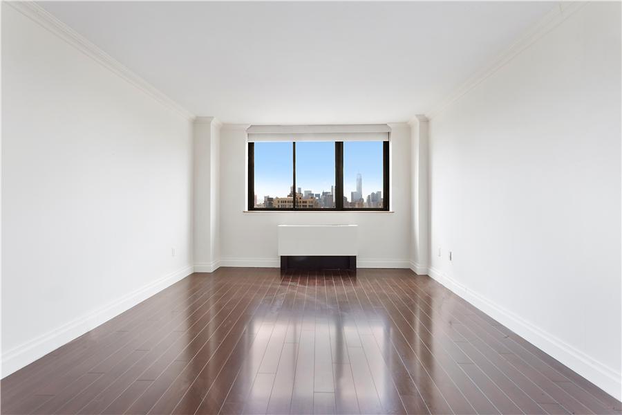 280 Park Avenue South, Unit 24E Manhattan, NY 10010 - Photo 2 of 6 an empty room with wooden floor and windows