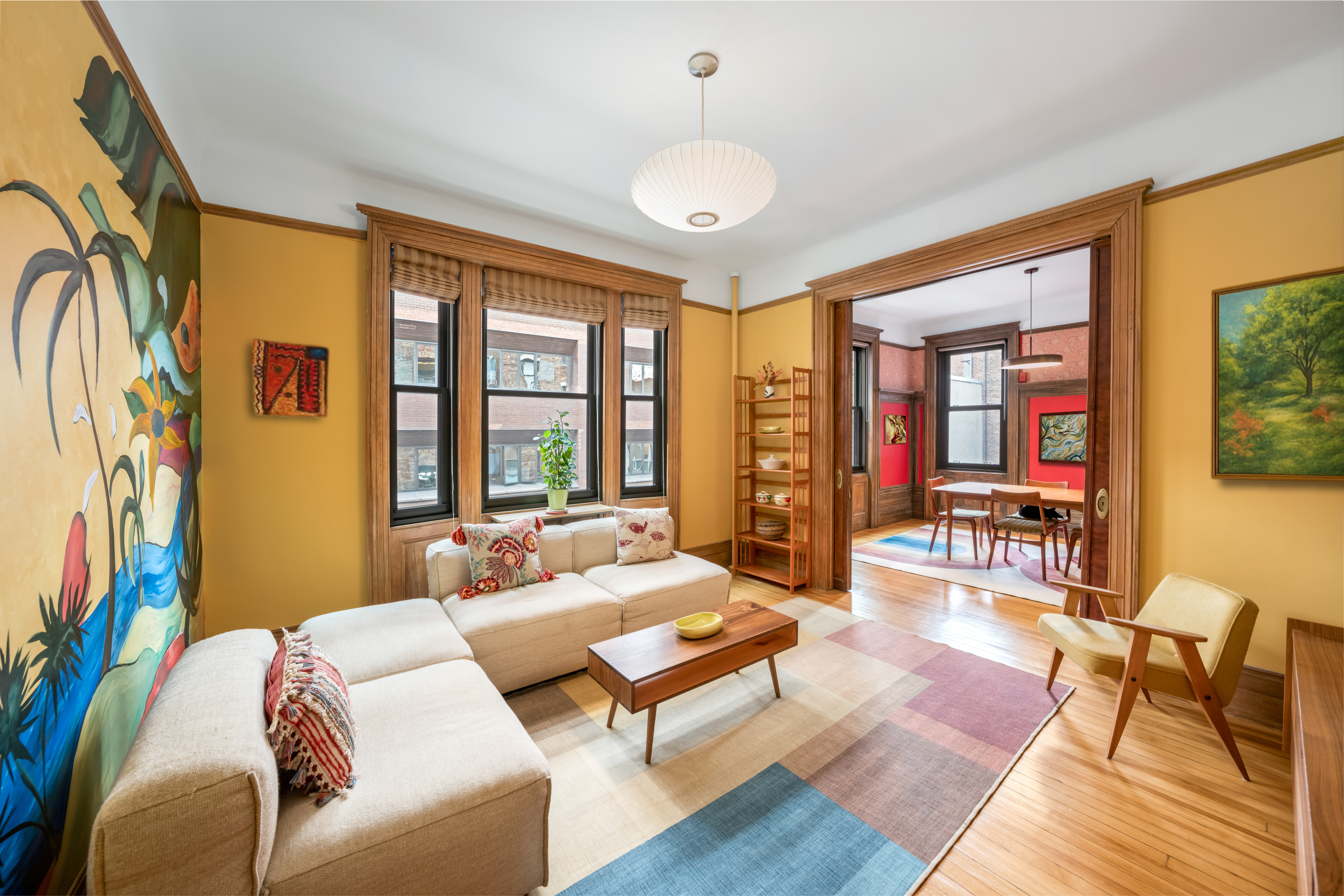 a living room with furniture and a floor to ceiling window