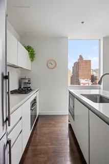 a kitchen with a sink and a stove top oven