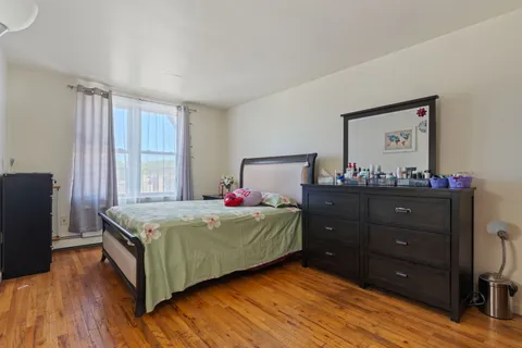 a bedroom with a bed and a window