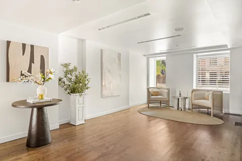 a dining room with furniture and wooden floor