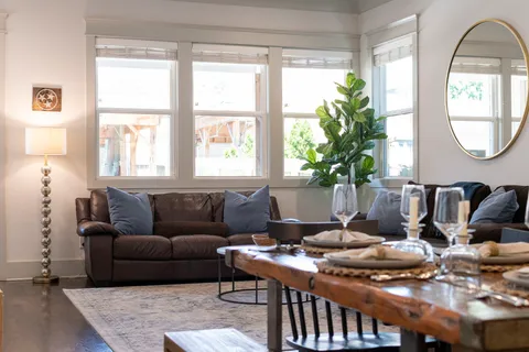 a living room with furniture a fireplace and a flat screen tv