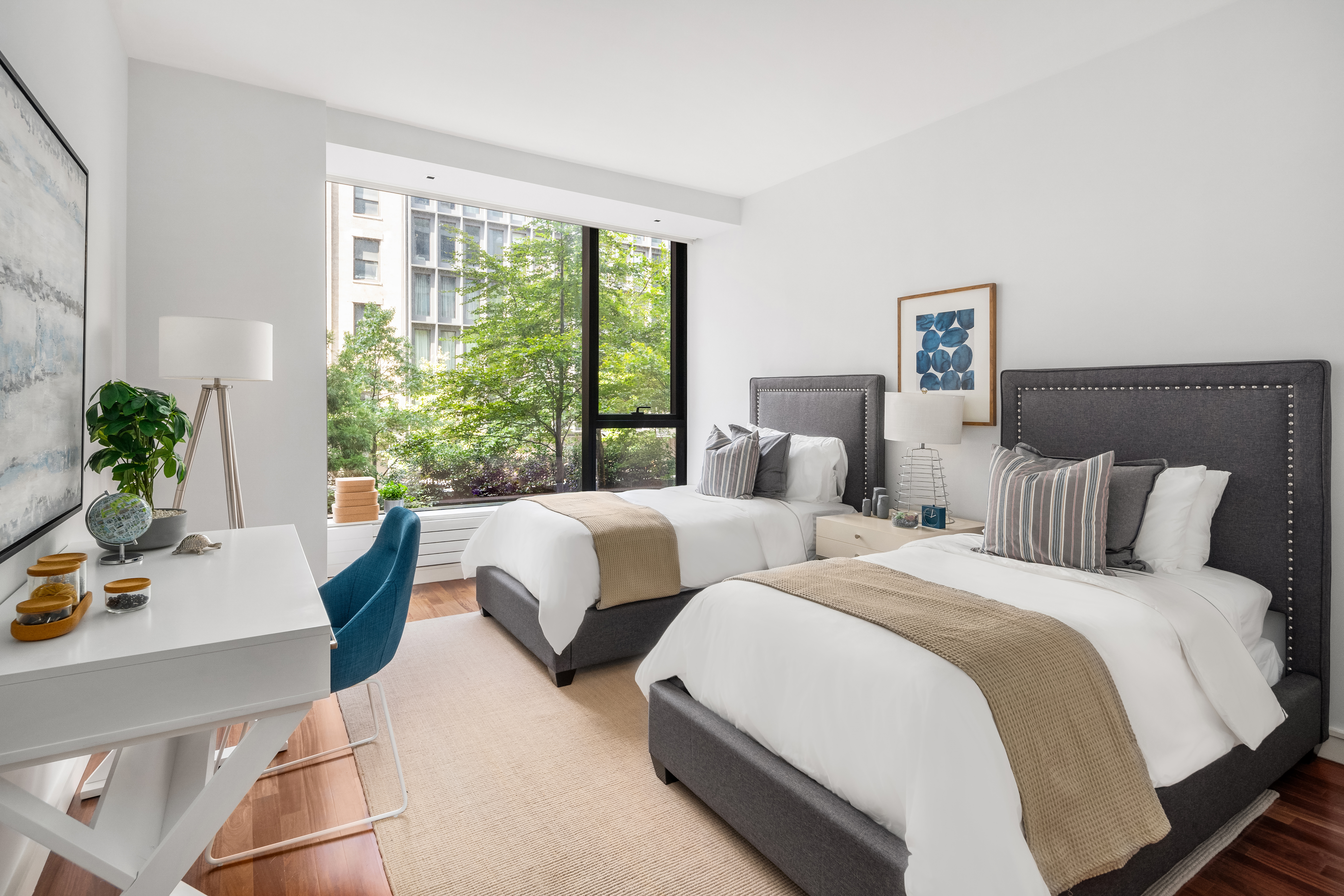 255 Hudson Street, Unit TH1 Manhattan, NY 10013 - Photo 7 of 9 a bedroom with two beds and a large window