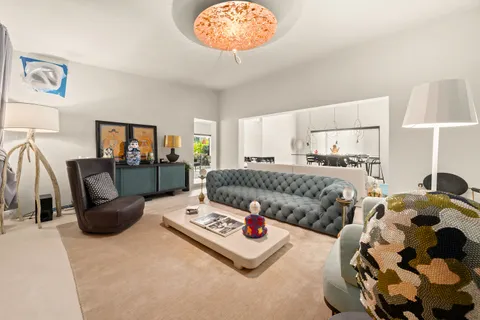 a living room with furniture and a lamp
