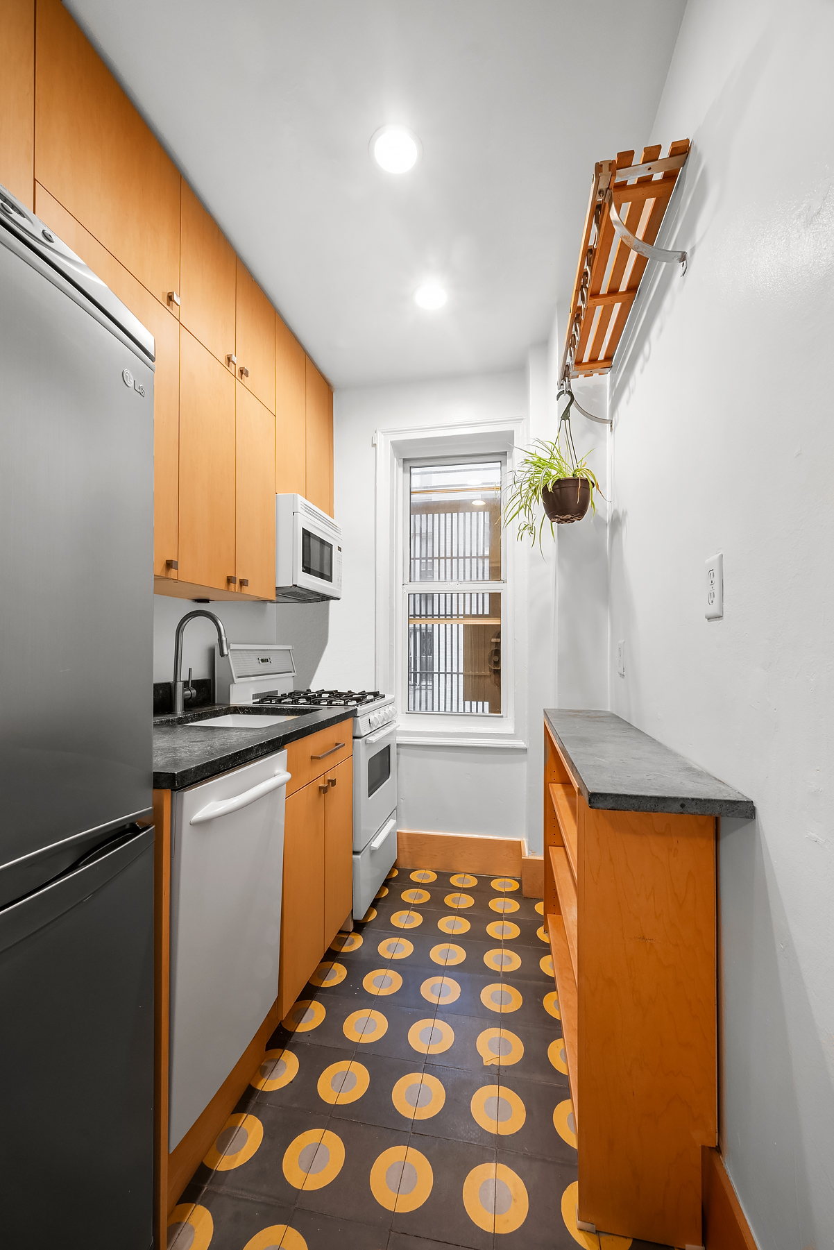 55 Eastern Parkway, Unit 1D Brooklyn, NY 11238 - Photo 3 of 5 a kitchen with stainless steel appliances granite countertop a sink and a refrigerator