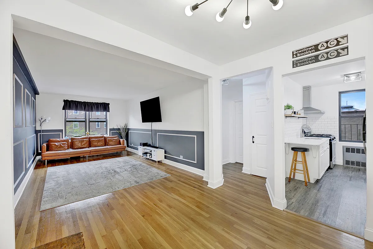 a bedroom with furniture and a flat screen tv
