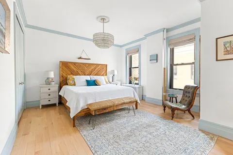 a bed room with a bed and a chair