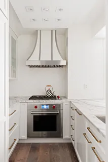 a stove top oven sitting inside of a kitchen