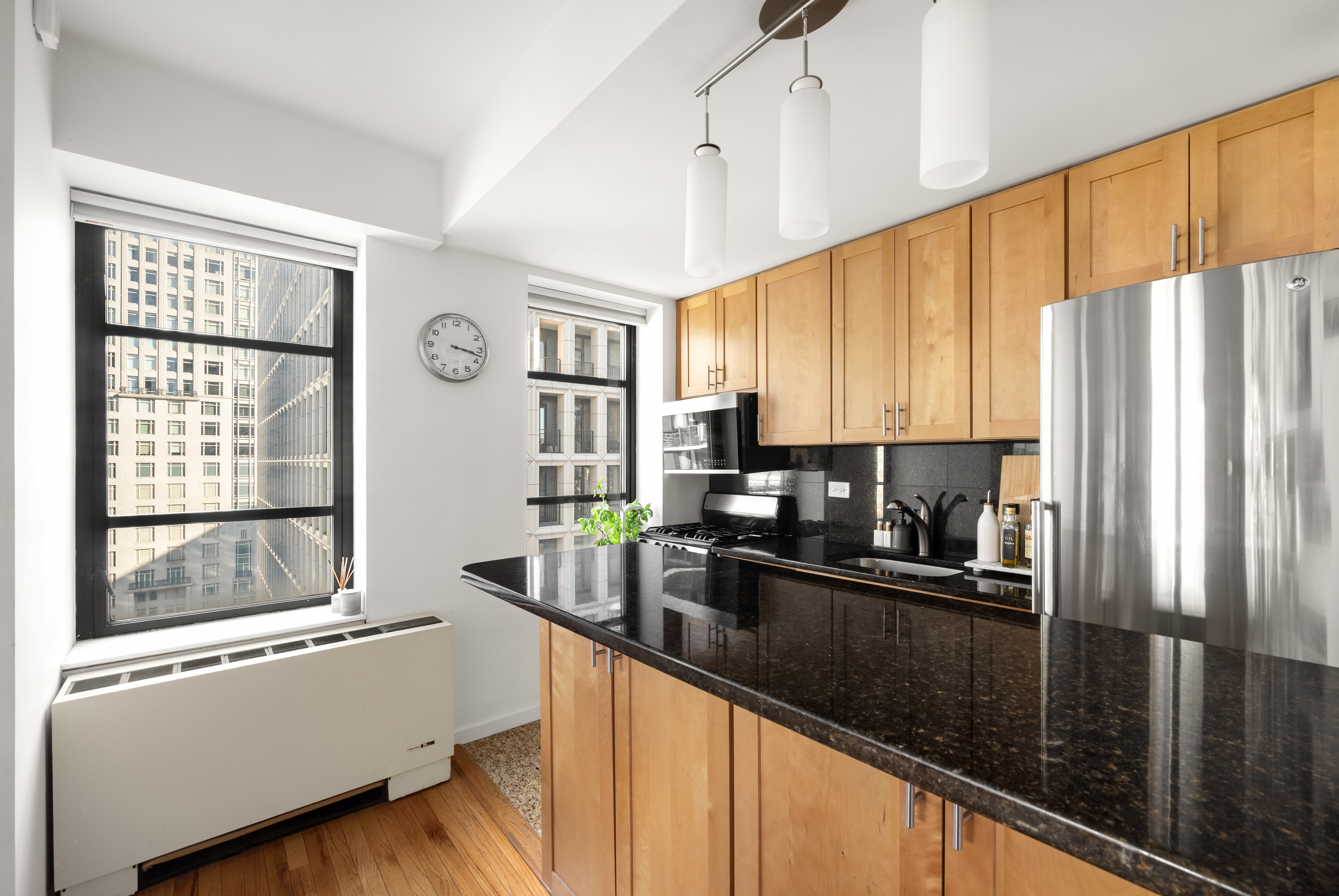43 West 61st Street, Unit 24Y Manhattan, NY 10023 - Photo 3 of 6 a kitchen with stainless steel appliances a refrigerator a sink a stove and cabinets