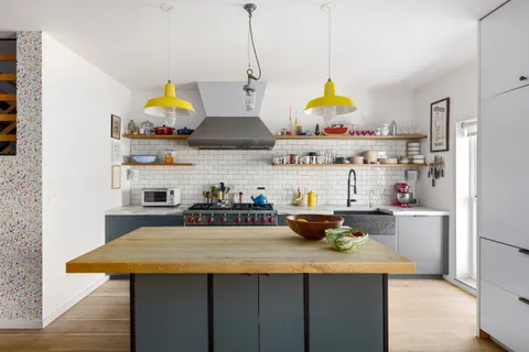 a kitchen with stainless steel appliances a stove a sink and a refrigerator