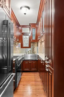 a large kitchen with stainless steel appliances granite countertop a sink and cabinets