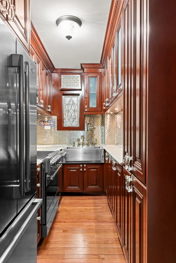 a large kitchen with stainless steel appliances granite countertop a sink and cabinets