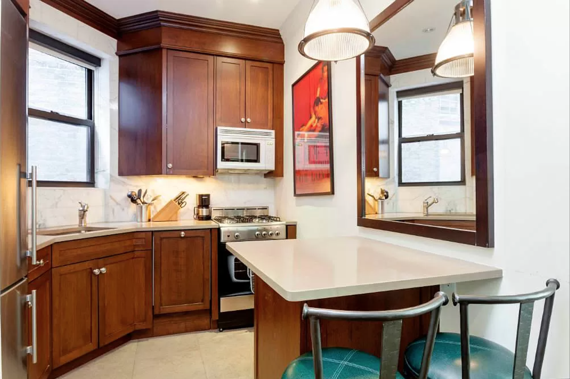 80 Charles Street, Unit 2R Manhattan, NY 10014 - Photo 2 of 5 a kitchen with a table chairs sink and cabinets