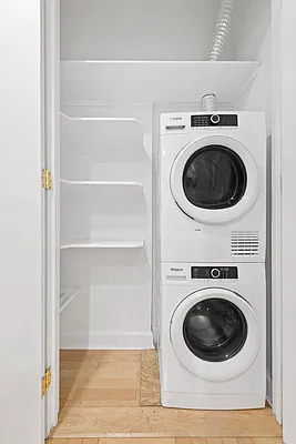 845 United Nations Plaza, Unit 56E Manhattan, NY 10017 - Photo 13 of 28 a utility room with dryer and washer
