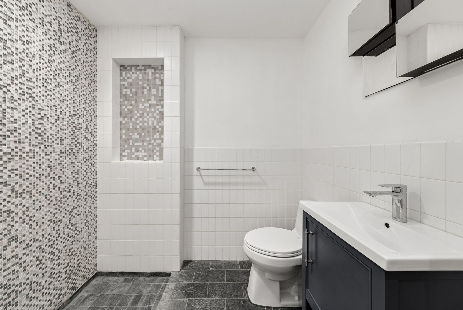 24 Beaver Street Manhattan, NY 10004 - Photo 21 of 25 a bathroom with a sink a toilet and shower