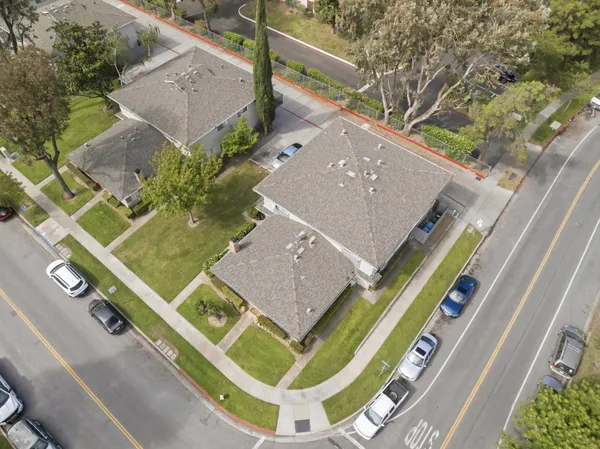 an aerial view of a house with a backyard