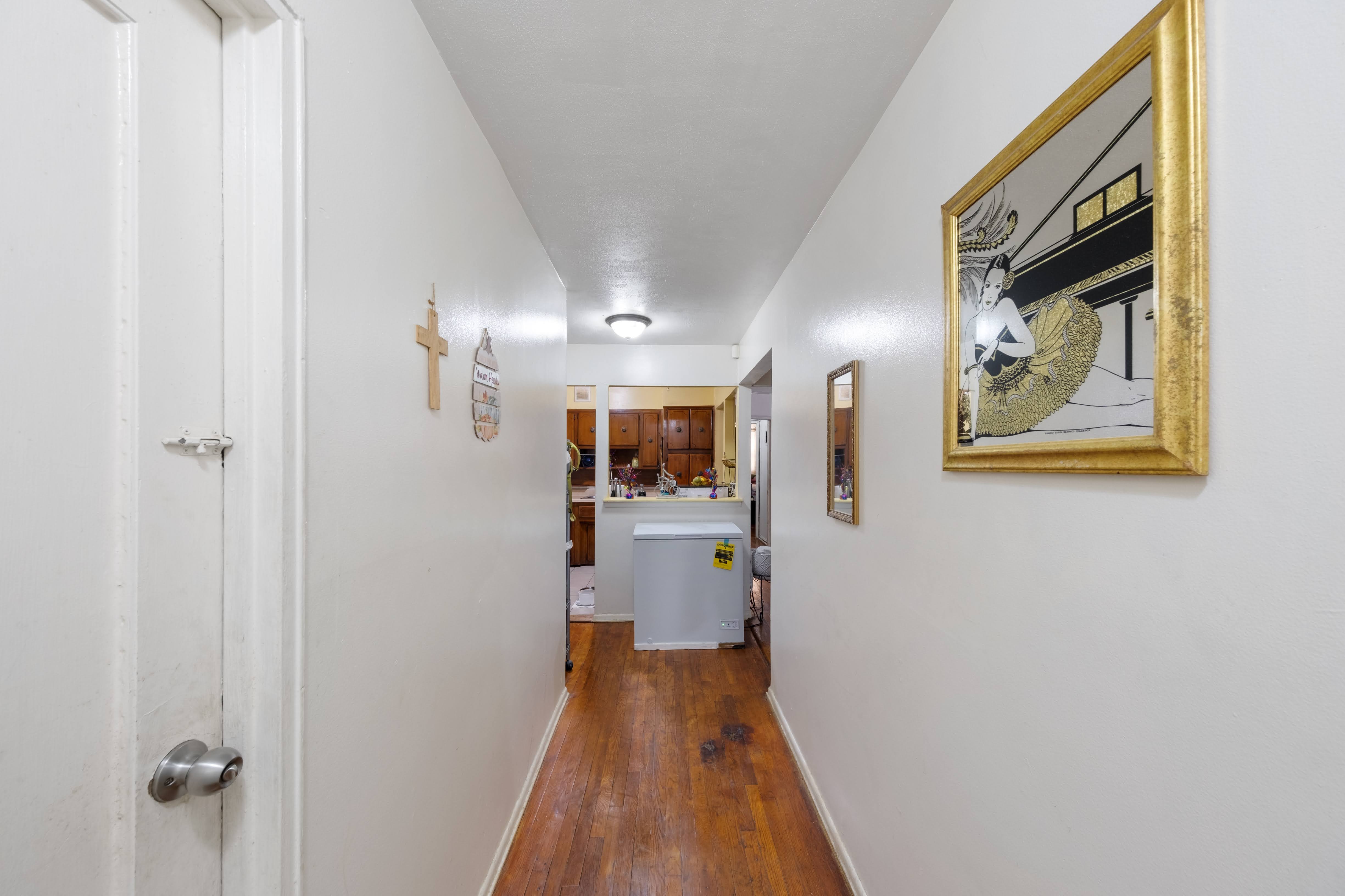 1464 East 84th Street Brooklyn, NY 11236 - Photo 11 of 22 a view of a hallway with wooden floor and staircase