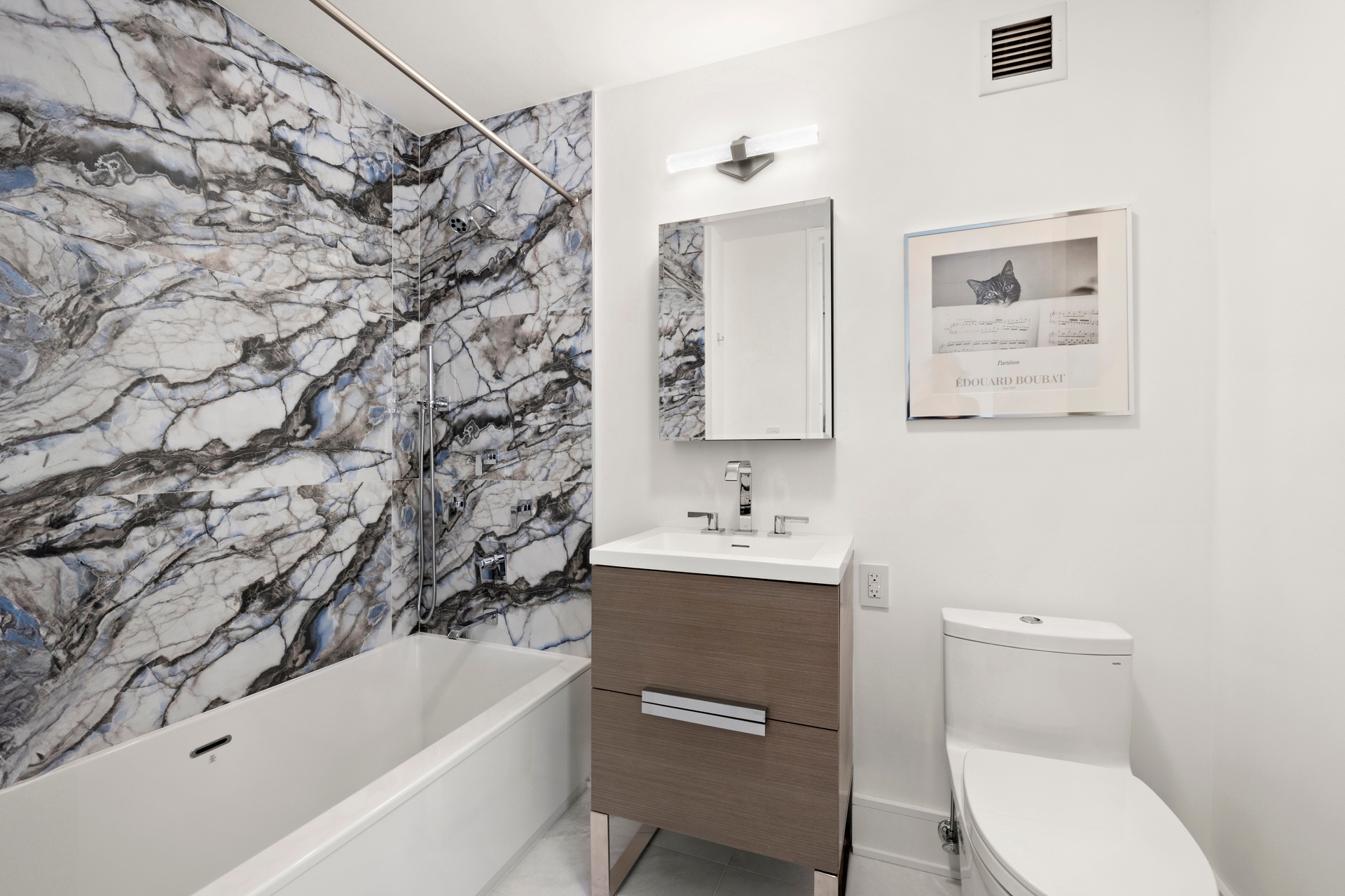 151 West 17th Street, Unit PHF-FURN Manhattan, NY 10011 - Photo 12 of 19 a bathroom with a toilet sink and mirror