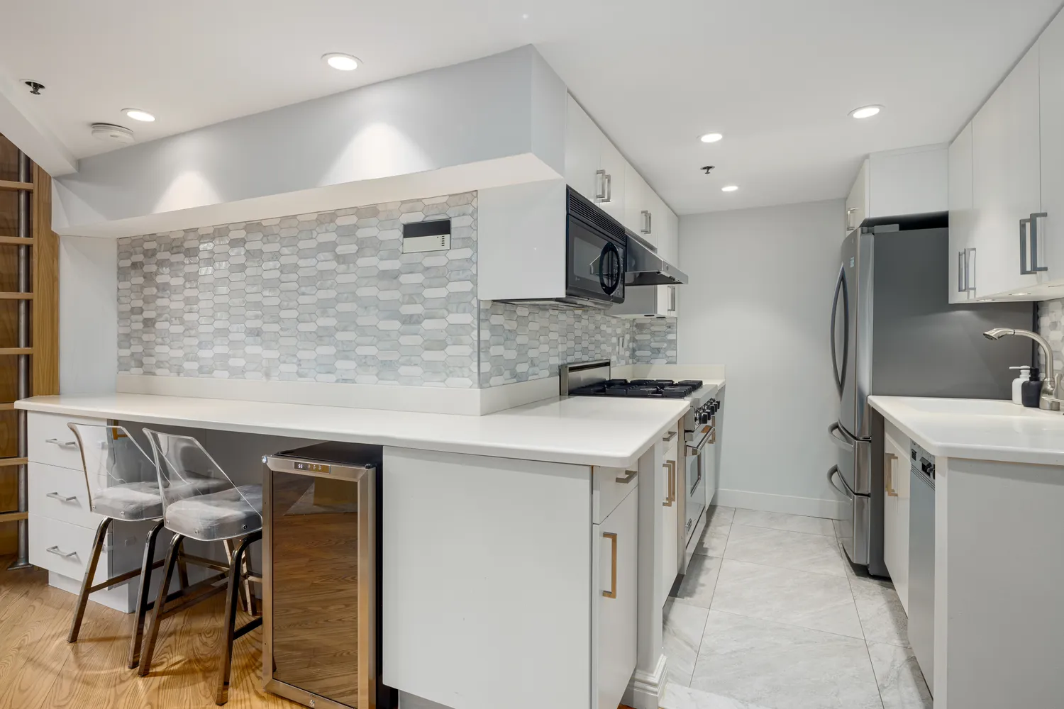 a kitchen with a sink a stove a refrigerator and a microwave