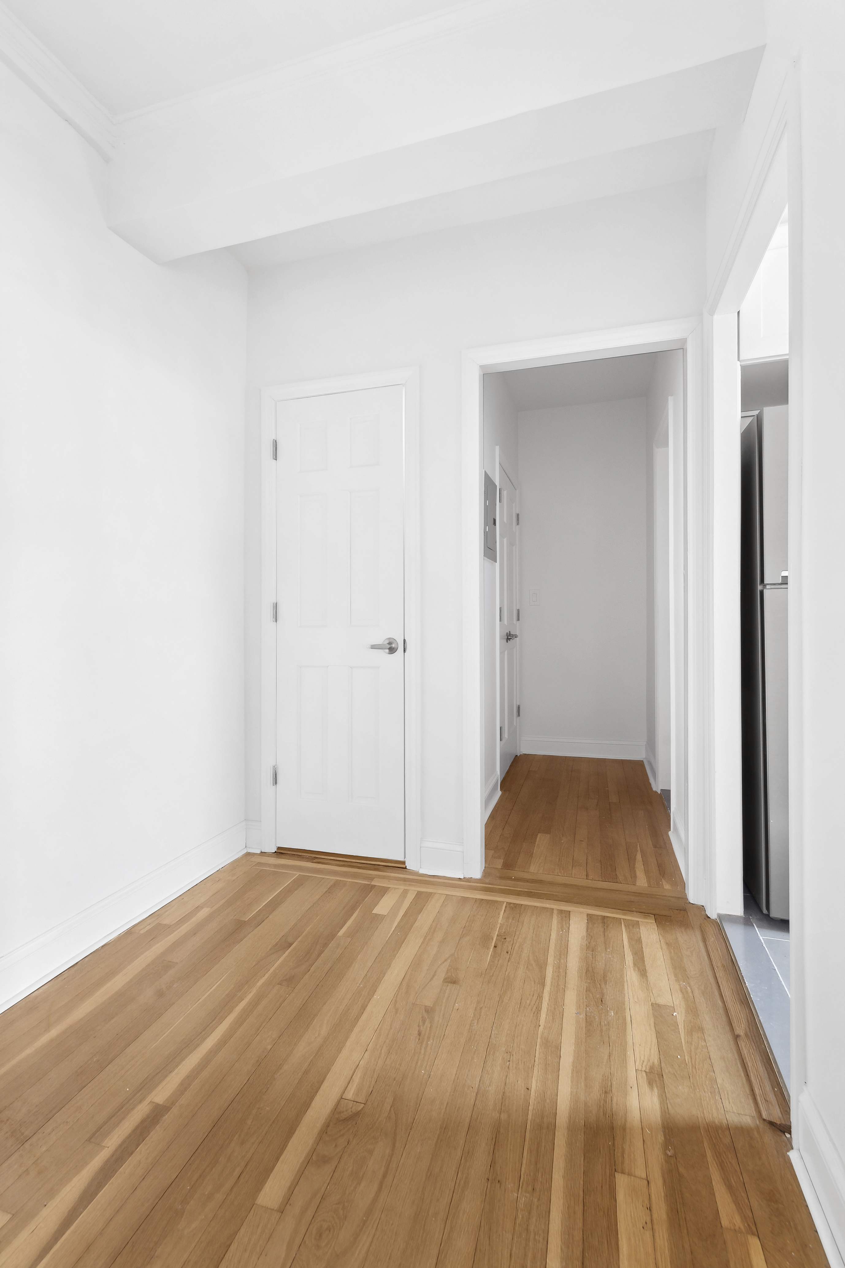 159-34 Riverside Drive West, Unit 7L90 Manhattan, NY 10032 - Photo 10 of 22 a view of a room with wooden floor and white walls