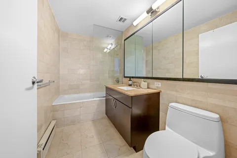 a bathroom with a sink a toilet and bathtub