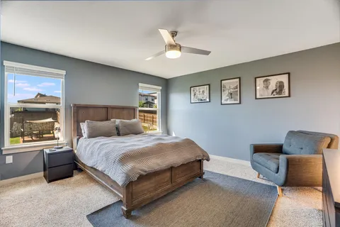 a bedroom with a bed lamp and window