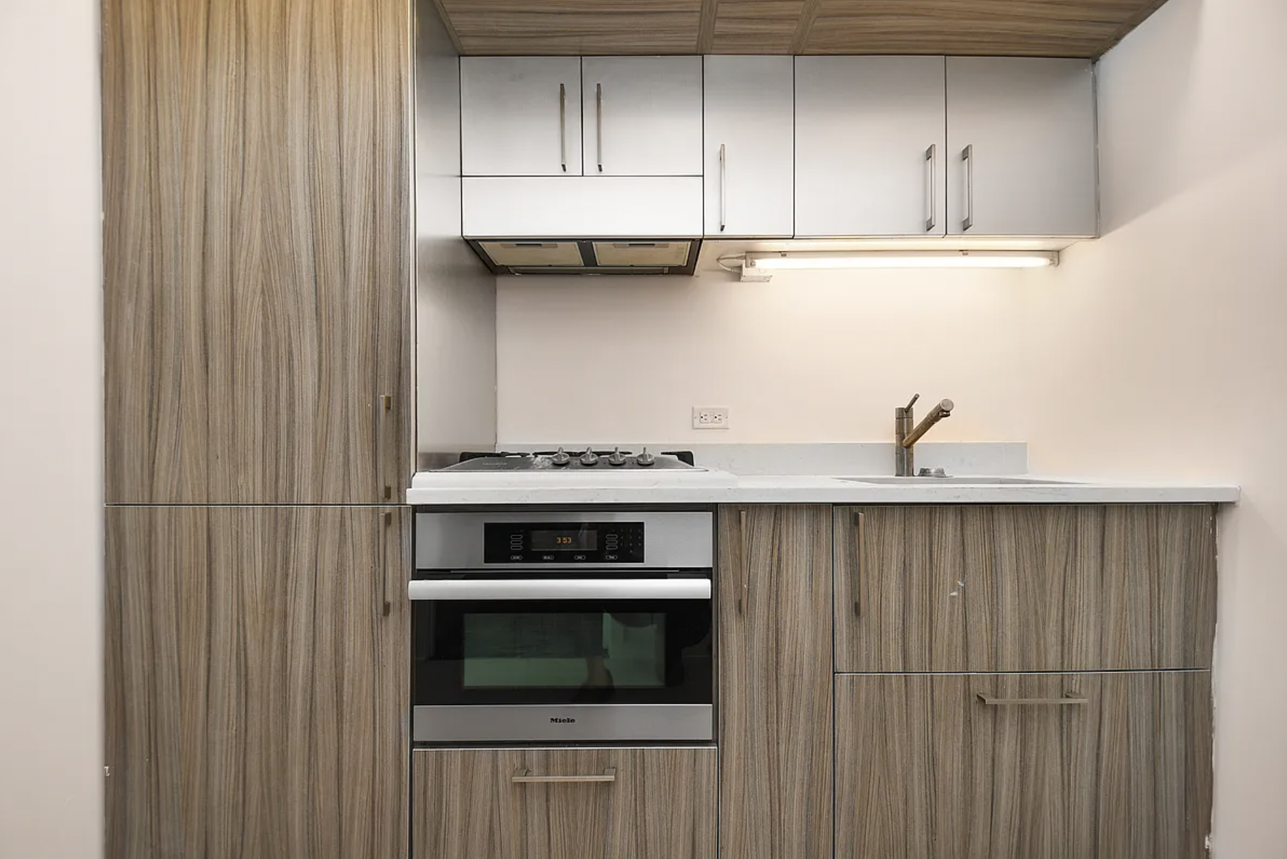 250 Bedford Avenue, Unit 129211 Brooklyn, NY 11249 - Photo 3 of 6 a kitchen with a stove and cabinets