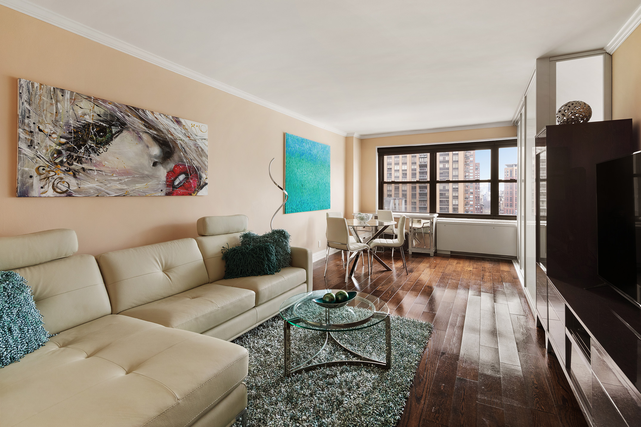 160 West End Avenue, Unit 25C Manhattan, NY 10023 - Photo 1 of 6 a living room with furniture and a flat screen tv