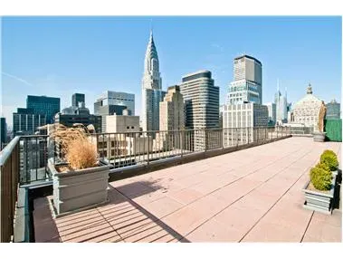 212 East 47th Street, Unit 21D Manhattan, NY 10017 - Photo 11 of 16 a view of a city with tall buildings
