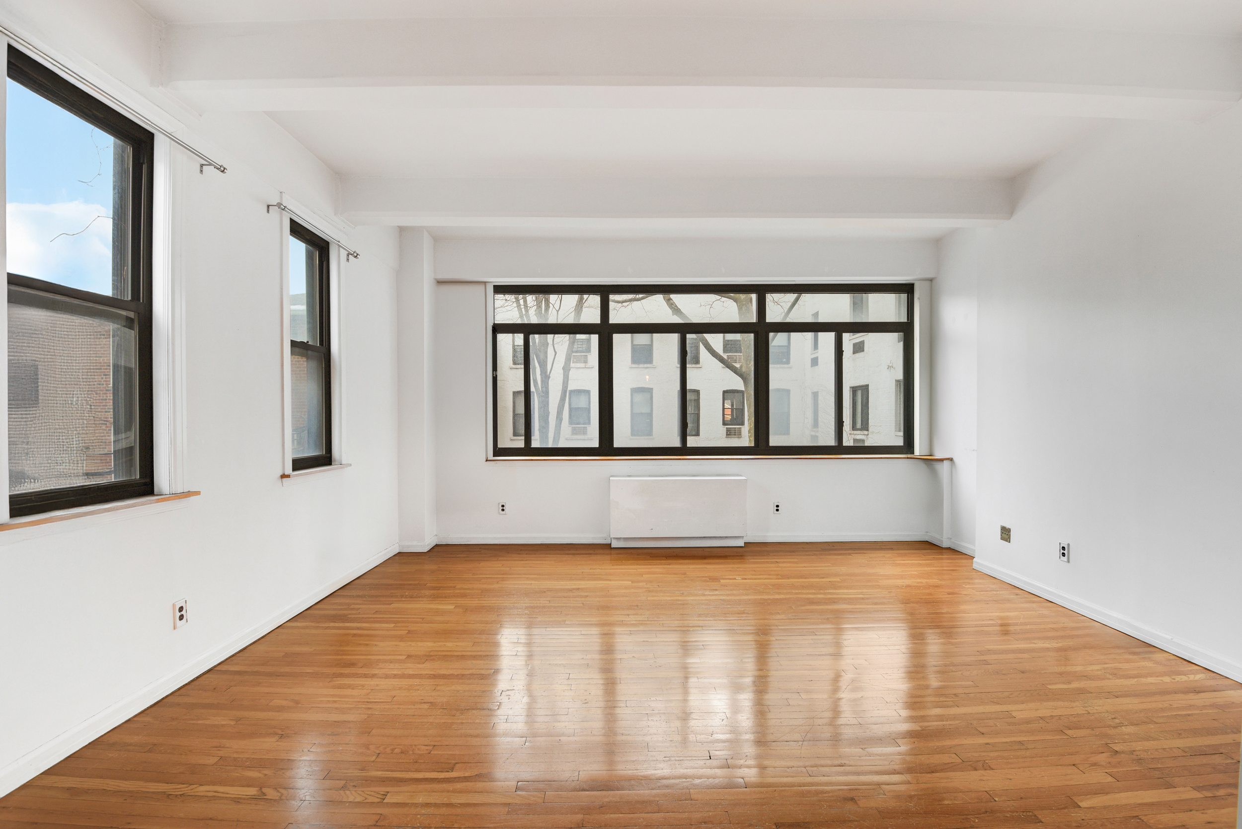 492 Henry Street, Unit 2A Brooklyn, NY 11231 - Photo 1 of 13 a view of empty room with wooden floor and fan