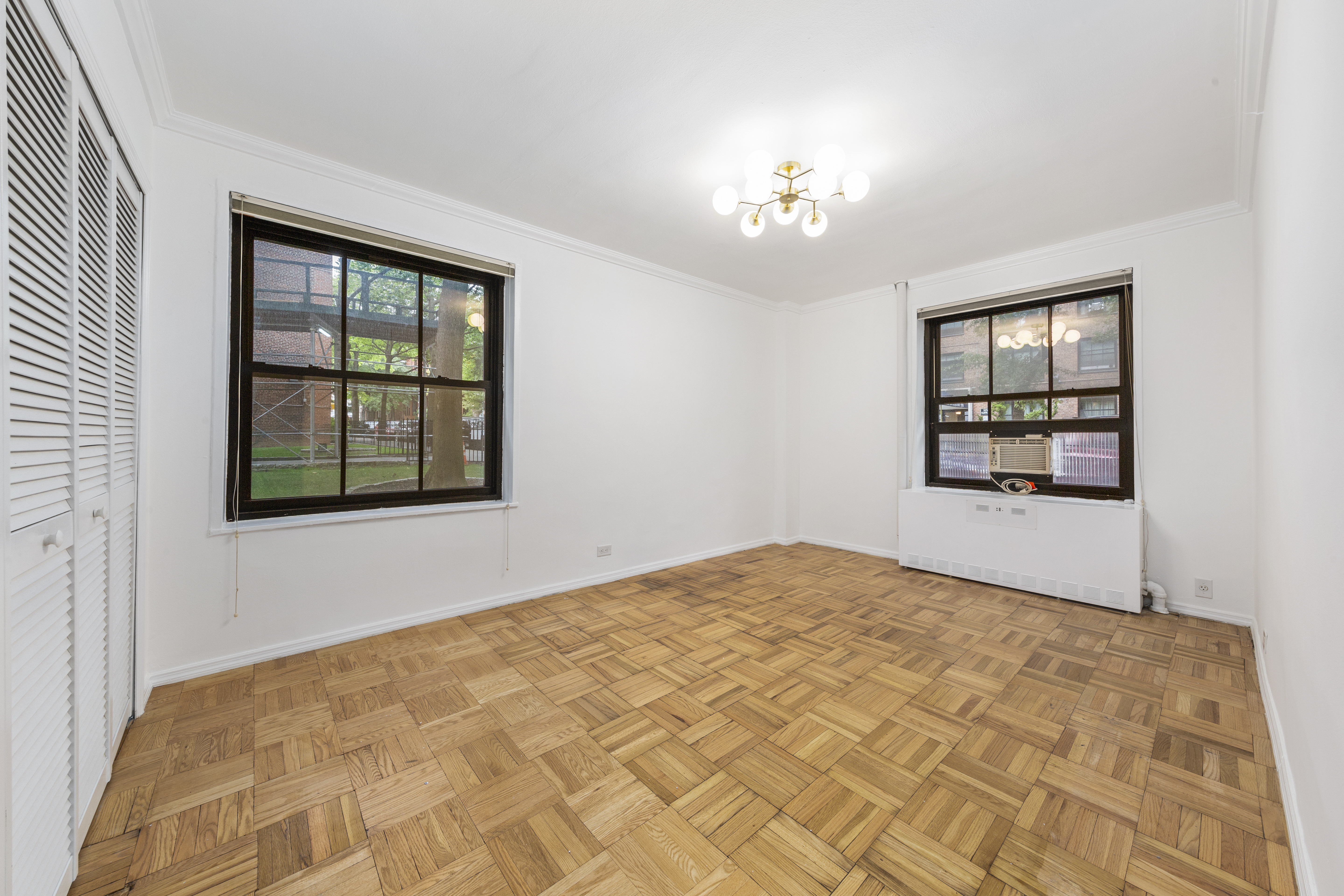 355 Clinton Avenue, Unit F1 Brooklyn, NY 11238 - Photo 7 of 20 a bedroom with a bed and a window