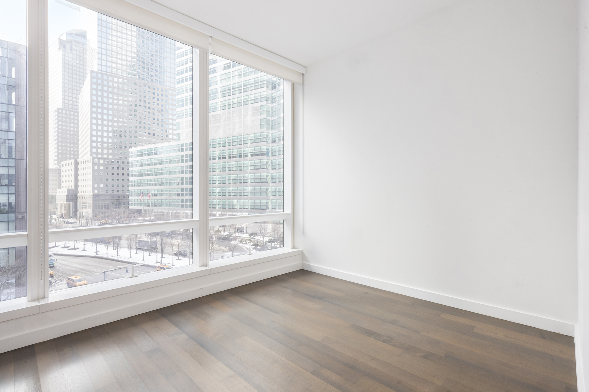 111 Murray Street, Unit 7D Manhattan, NY 10007 - Photo 14 of 17 a view of an empty room with wooden floor and a window