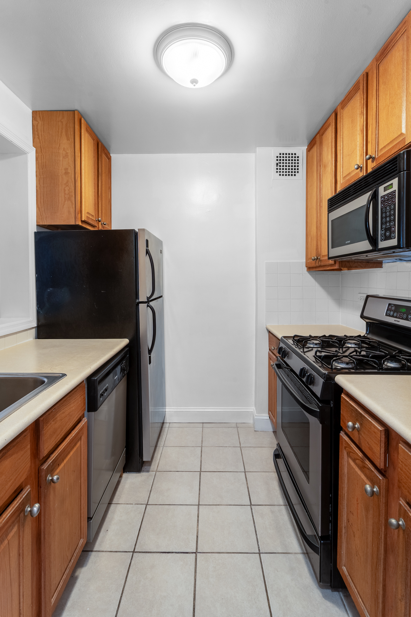 2750 Johnson Avenue, Unit 6E Bronx, NY 10463 - Photo 3 of 14 a kitchen with stainless steel appliances granite countertop a stove a microwave and a sink