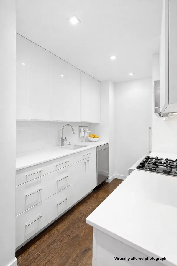 a kitchen with a sink a stove and cabinets