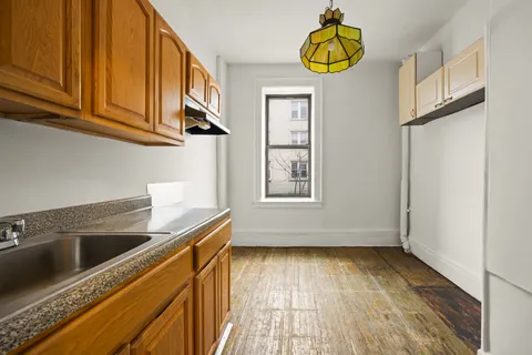 a view of a kitchen with wooden floor and cabinet