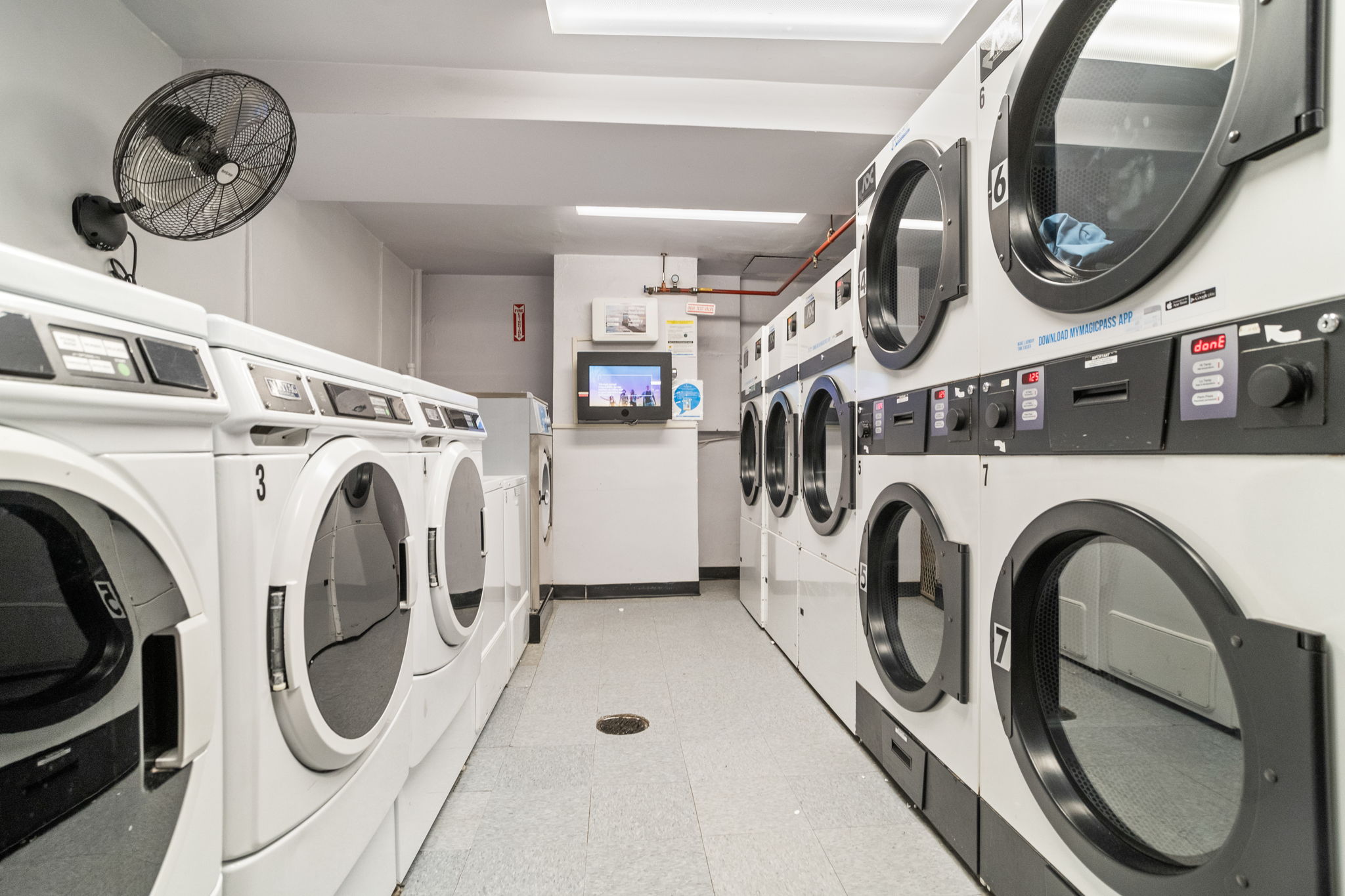 401 East 65th Street, Unit 12F Manhattan, NY 10065 - Photo 14 of 18 a utility room with dryer and washer