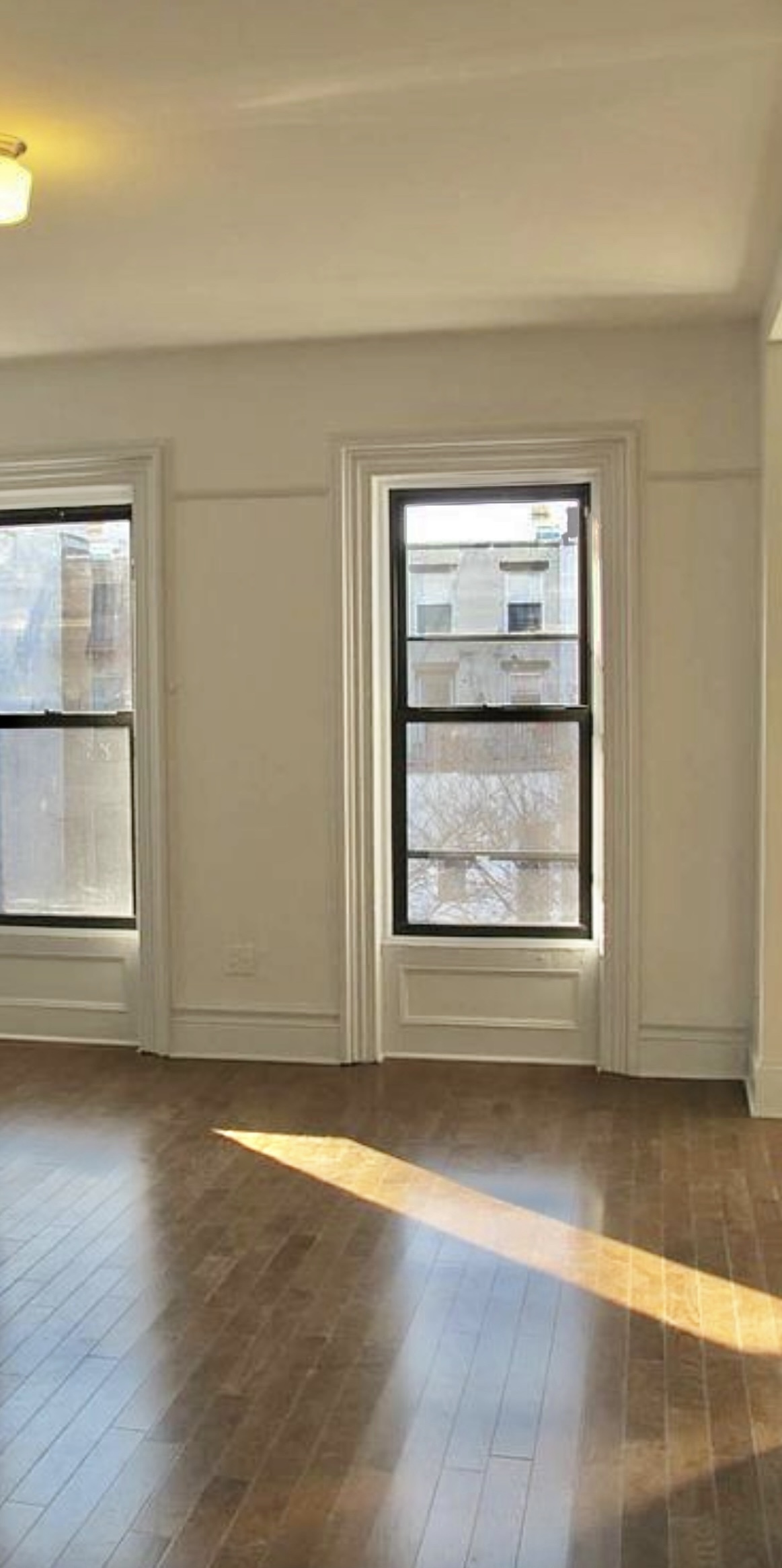 68 Downing Street, Unit 3 Brooklyn, NY 11238 - Photo 3 of 7 an empty room with wooden floor and windows