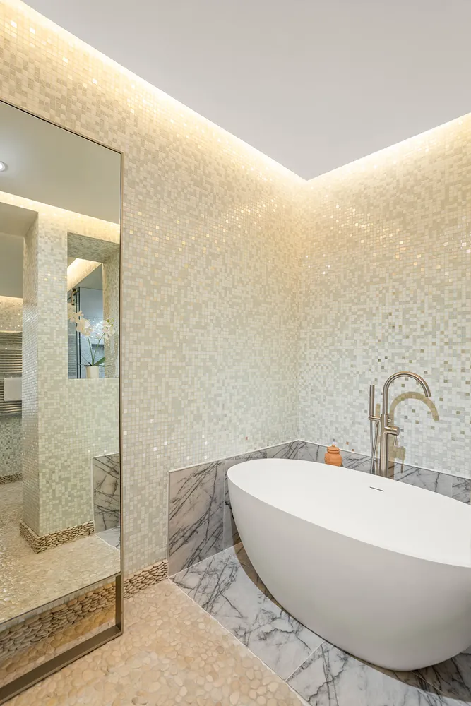 a white bath tub sitting next to a bathroom