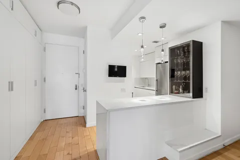 a view of hallway with sink and mirror