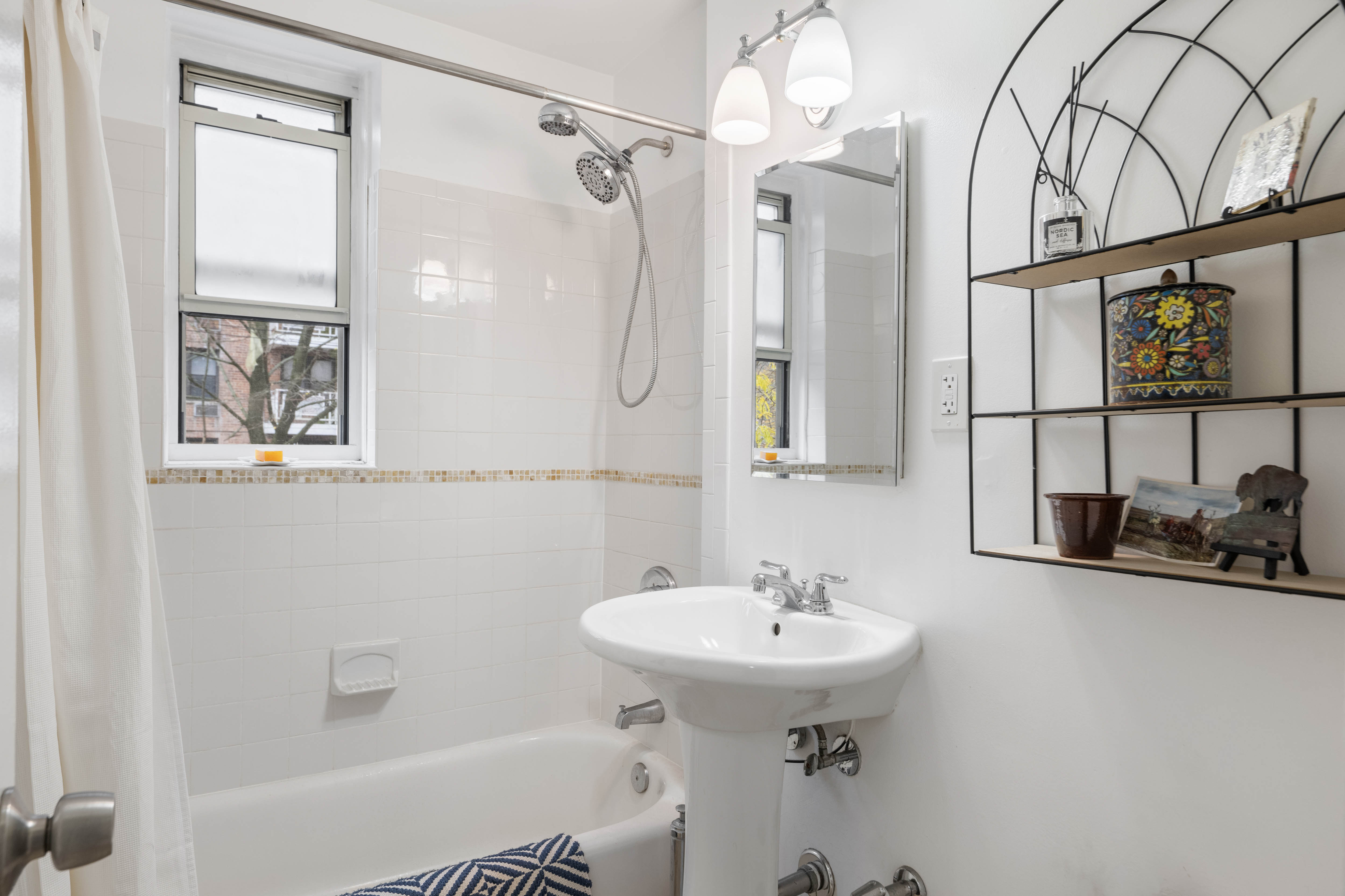 255 Fieldston Terrace, Unit 2L Bronx, NY 10471 - Photo 12 of 14 a bathroom with a sink a toilet and shower